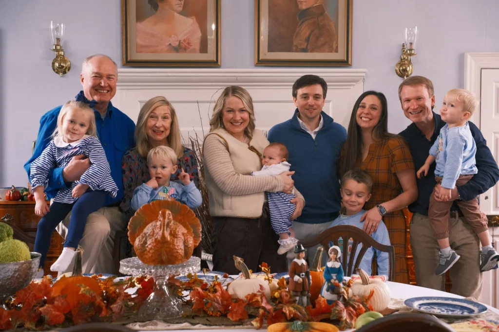 Three generations gathered around a Thanksgiving table at home