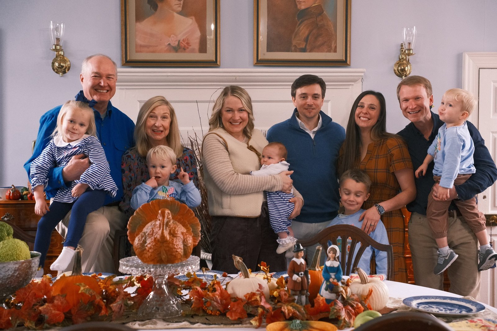Three generations gathered around a Thanksgiving table at home