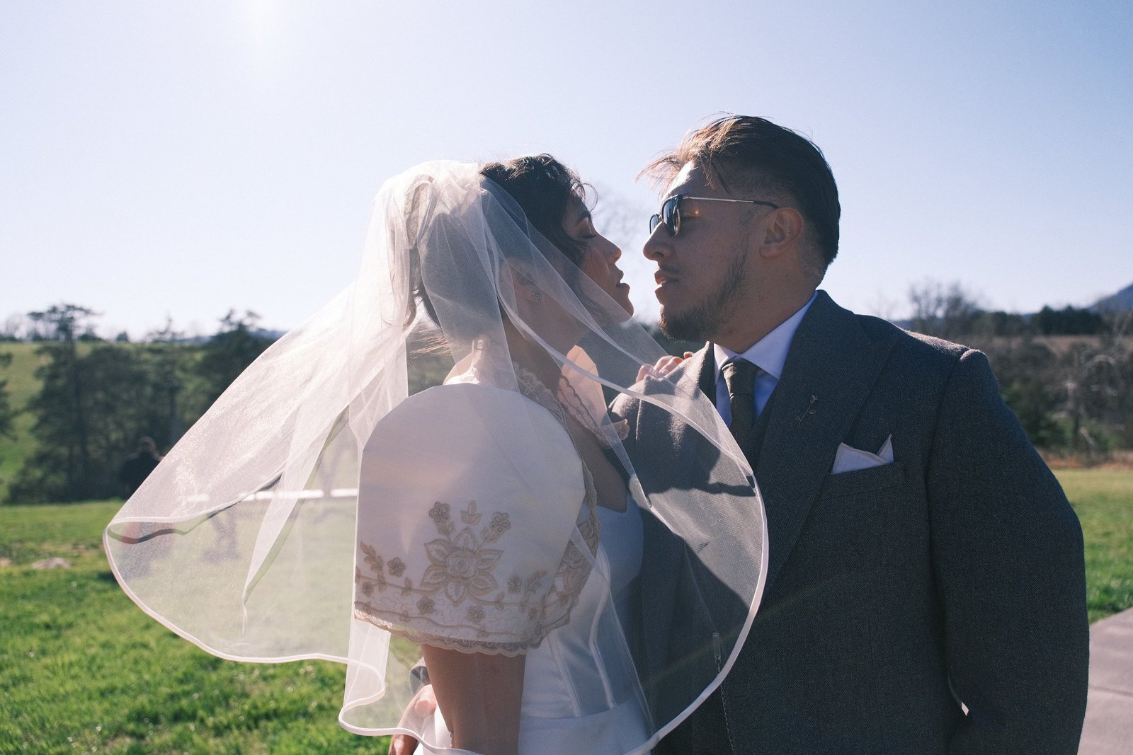 Bride and groom sharing a kiss beneath her veil in Luray, Virginia